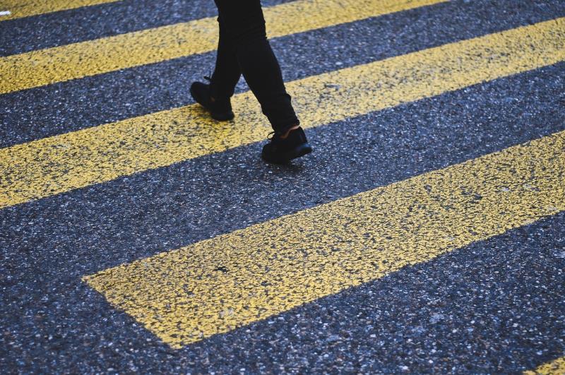 A pedestrian crossing on a quiet road  a symbol of unquestioned repetition